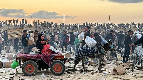 This photo, provided by an American contractor on condition of anonymity because they were revealing their employers’ internal operations, shows a woman slumped over in a donkey cart after the contractor said she was hit in the head with part of a stun grenade at a food distribution site in Gaza run by the Gaza Humanitarian Foundation in June 2025.