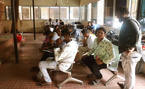 People wait at the sub-registrar’s office in Bhubaneswar.