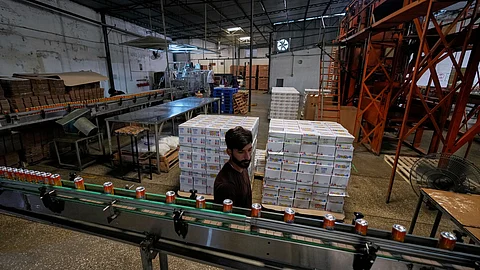 Employees of the Murree Brewery work at a soft drink production unit of the factory, in Rawalpindi, Pakistan, Monday, June 23, 2025