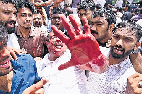 Youth Congress workers carry a person injured during the protest march to Kottayam Medical College Hospital on Friday.
