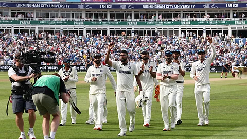 India's Mohammed Siraj (C) is congratulated as he leaves the field having taken six wickets, on day three of the second cricket test match between England and India at Edgbaston cricket ground in Birmingham, central England on July 4, 2025.