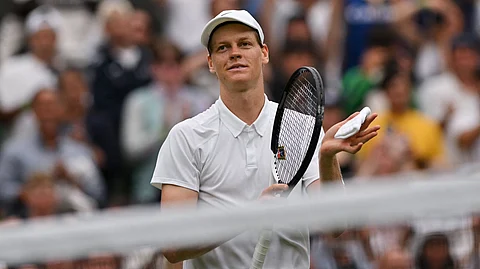 Italy's Jannik Sinner celebrates after victory over Spain's Pedro Martinez at the end of their men's singles third round tennis match on the sixth day of the 2025 Wimbledon Championships at The All England Lawn Tennis and Croquet Club in Wimbledon, southwest London, on July 5, 2025.
