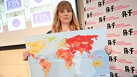 Reporters Without Borders Director of Operations and Campaigns Rebecca Vincent shows the new 2022 World Press Freedom Index map during the Reporters Without Borders press conference in London on May 3, 2022. (AFP via VOA)