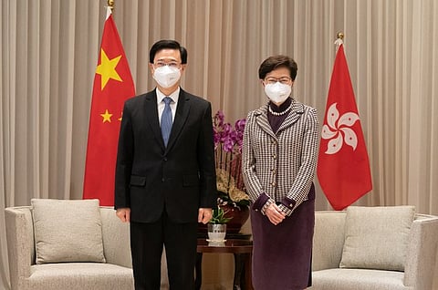 Hong Kong Chief Executive-elect John Lee (L), the former security chief who oversaw the crackdown on Hong Kong's democracy movement, poses for photos with incumbent Chief Executive Carrie Lam in Hong Kong a day after he was annointed by a small group of Beijing loyalists, May 9, 2022.
(RFA)