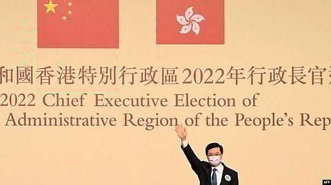 John Lee waves after becoming the city's new chief executive in Hong Kong on May 8, 2022. (AFP via VOA)