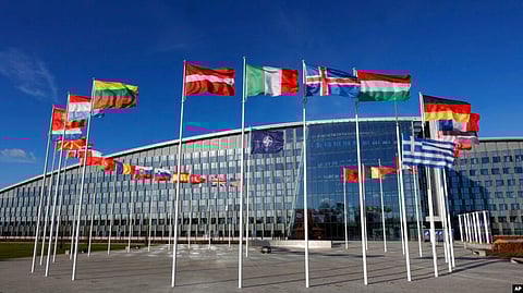 Flags flutter in the wind outside NATO headquarters in Brussels, Feb. 7, 2022. (AP via VOA)