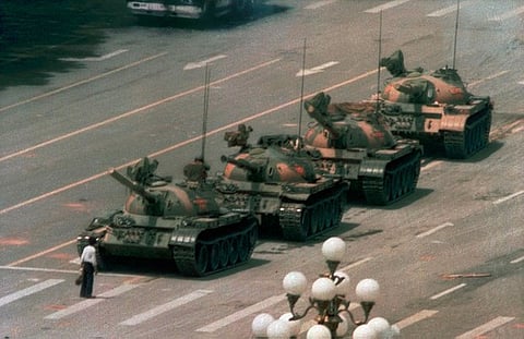 A photo of a man staring down a People's Liberation Army tank on Chang-An Street in Beijing that has become an iconic symbol of the Tiananmen massacre, June 4, 1989.