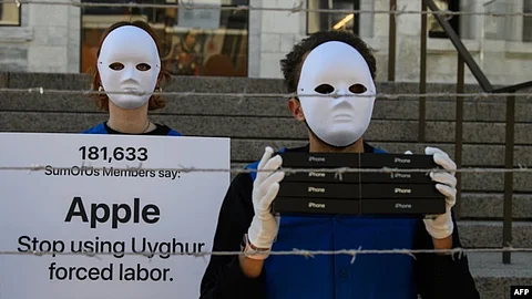 Activists set up a mock Uyghur forced labor camp outside the Apple flagship store on March 4, 2022, in Washington, DC. Demonstrators called on tech giant Apple to stop using Uyghur forced labor.