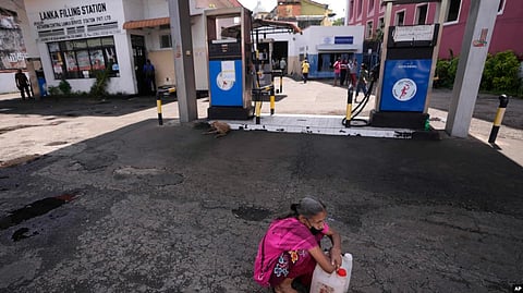 A Sri Lankan woman waits in a deserted gas station, hoping to buy kerosene oil for cooking in Colombo, Sri Lanka, May 26, 2022. Sri Lanka has run out of fuel, according to a report in Monday's Daily Mirror.