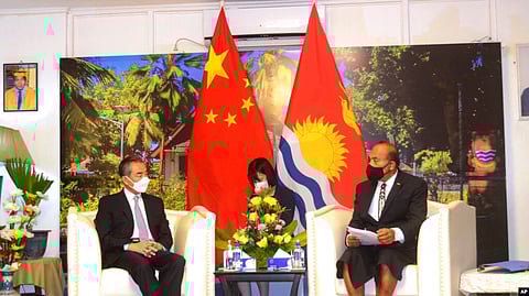 In this photo released by Xinhua News Agency, Kiribati President and Foreign Minister Taneti Maamau, right, meets with Chinese Foreign Minister Wang Yi in Tarawa, Kiribati, May 27, 2022.
