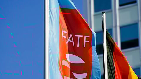 A flag with the logo of the Financial Action Task Force (FATF) waves in the wind next to the German national flag during a meeting of the group at the Congress Center in Berlin, June 17, 2022.