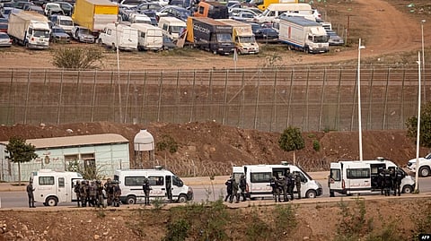 Paramilitaries of the Moroccan Auxiliary Forces stand guard by the border fence separating Morocco from Spain's North African Melilla enclave after an attempted assault of migrants near Nador, March 4, 2022.