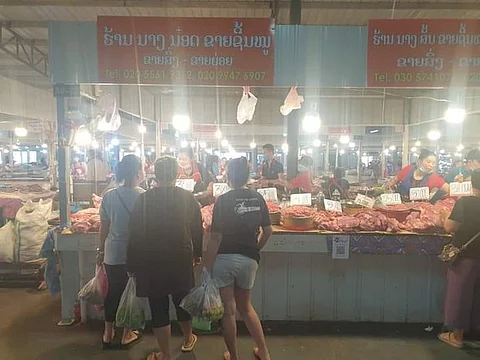 A file photo of a pork seller at a market in Vientiane, Laos, May 31, 2022.