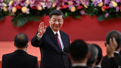 China's President Xi Jinping waves following his speech after a ceremony to inaugurate the city's new leader and government in Hong Kong on July 1, 2022, on the 25th anniversary of the city's handover from Britain to China.