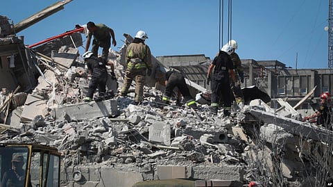 Ukrainian State Emergency Service firefighters clear debris at damaged residential building in the town of Serhiivka, located about 50 kilometers (31 miles) southwest of Odesa, Ukraine, July 1, 2022.