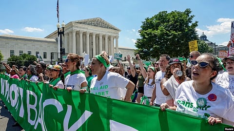 Abortion rights activists march past United States Supreme Court to protest the court's ruling overturning the landmark Roe v.Wade abortion decision, in Washington, June 30, 2022.