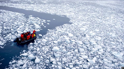 In this Jan. 22, 2015, photo, a zodiac carrying a team of international scientists heads to Chile's station Bernardo O'Higgins, Antarctica.