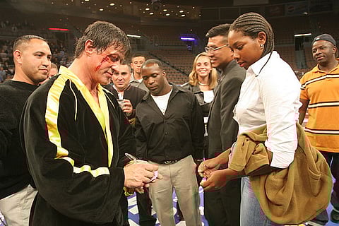 Actor Sylvester Stallone, who played Rocky in the Rocky movie franchise, signs an autograph for Camp Pendleton Marine Lance Cpl. Lakeya Benton at the Mandalay Bay in Las Vegas on December 6, 2005.