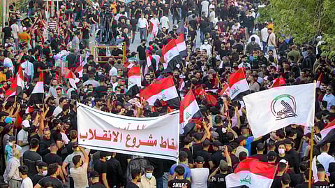 Supporters of the Iran-backed Shiite Coordination Framework rally on Aug. 12, 2022, to denounce the followers of influential Shiite cleric Muqtada al-Sadr who stormed the parliament last month and have since been holding a sit-in outside the assembly building in Baghdad.