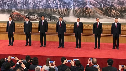 New members of the Politburo Standing Committee, from left, Han Zheng, Wang Huning, Li Zhanshu, Xi Jinping, Li Keqiang, Wang Yang, and Zhao Leji stood together on Oct. 25, 2017, the day after the end of the 19th Communist Party Congress.