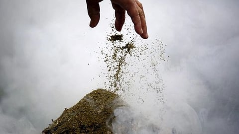A woman offers incense while offering prayers during a function organized to mark the 80th birthday celebration of Tibetan spiritual leader the Dalai Lama in Kathmandu, Nepal, July 6, 2015.