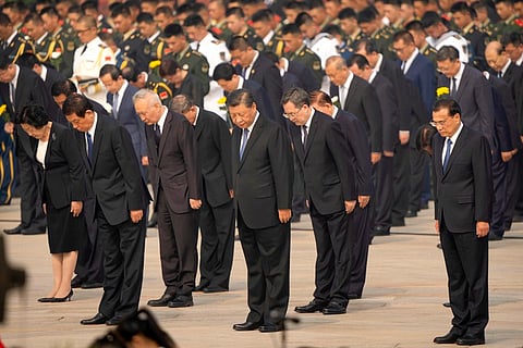 Chinese President Xi Jinping, center, and other Chinese leaders bow during a ceremony to mark Martyr's Day at the Monument to the People's Heroes at Tiananmen Square in Beijing, Sept. 30, 2022.