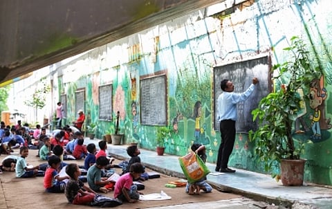 Rajesh Kumar Sharma, 52, who hails from an adjacent state Uttar Pradesh, runs a free 'school' for Class one to eight under a flyover near Yamuna Bank Depot in Delhi.