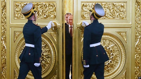 Honor guards open the doors for Russian President Vladimir Putin followed by Crimean leaders entering the hall for the signing ceremony of a treaty for Crimea to join Russia in the Kremlin in March 2014.