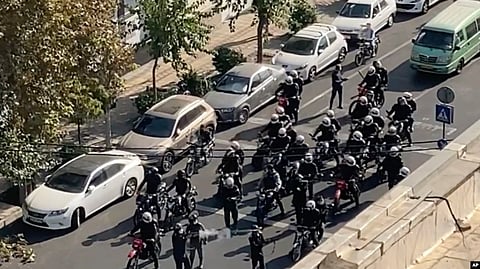 This image from a video taken by an individual not employed by the AP and obtained outside Iran shows police arriving to disperse a protest to mark 40 days since the death of Mahsa Amini, in Tehran, Oct. 26, 2022.