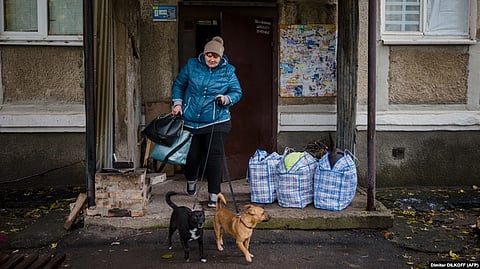 A woman and her dogs evacuate from the town of Bakhmut in the Donetsk region on October 25.