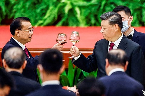 Chinese President Xi Jinping and Premier Li Keqiang raise glasses during a reception at the Great Hall of the People on the eve of the Chinese National Day in Beijing, China, Sept. 30, 2022.
