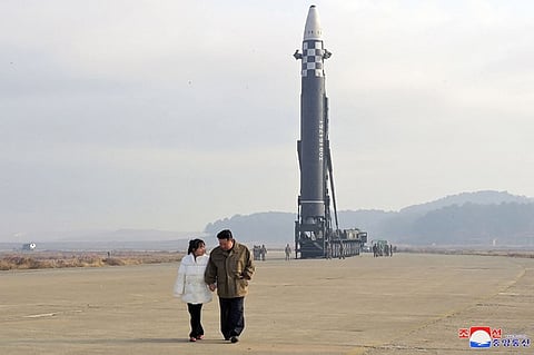 Kim Jong Un with his daughter at a missile launch site.