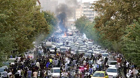 FILE - Demonstrators chant slogans during a protest over the death of a woman detained by the morality police, in downtown Tehran, Iran, Sept. 21, 2022, in this photo taken by an individual not employed by the Associated Press and obtained by the AP.