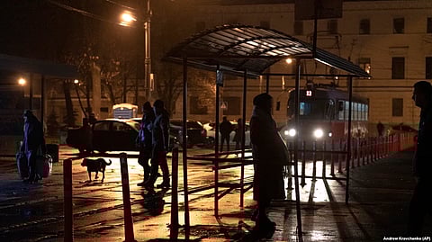 Ukraine: People wait at a tram stop during a blackout in Kyiv.