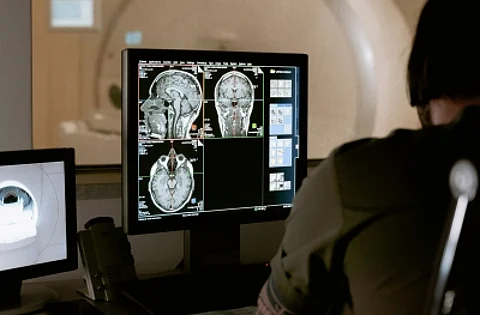 A woman has been diagnosed with a brain tumour after she claimed that voices in her head told her to have a CT scan.