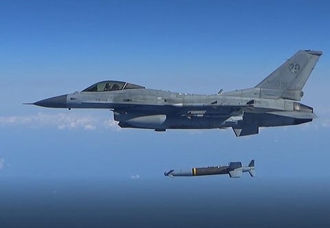 A South Korean Air Force's F-15K fires an air-to-surface missile towards the north of the maritime border with North Korea, in this handout provided by South Korea's Defence Ministry on November 2, 2022.