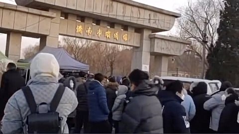 People throng Jinan Funeral Home in Jinan, Shandong province, China, in this screenshot obtained from a social media video released on Monday, Dec. 26, 2022. (Reuters)