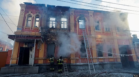 Firefighters work outside an office building destroyed by shelling in Donetsk, Ukraine, on December 5. (Reuters)
