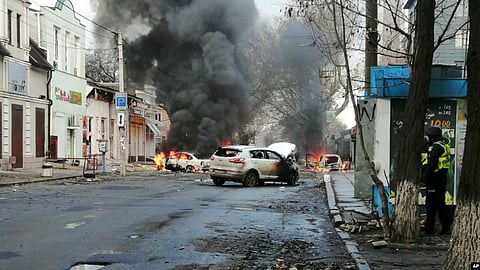 FILE - Cars burn and smoke raises after a deadly Russian rocket attack hit the city center in Kherson, Ukraine, Dec. 24, 2022. (AP)