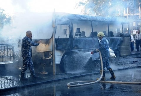 Firefighters and military personnel are putting out the fire on a bus under the President Bridge in Damascus, Syria, on Oct. 20, 2021. (Str/Xinhua/IANS)