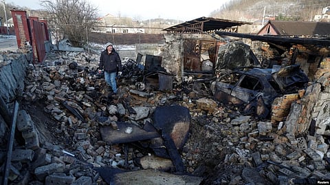 Local resident Mykola Kobzarenko inspects the remains of his garage destroyed during a Russian drone strike in the village of Stari Bezradychi, in Kyiv region, Dec. 19, 2022. (Reuters)