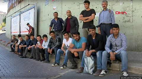 Turkmen migrants wait on the street in hopes of getting a job in Istanbul.