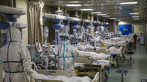 FILE - Medical workers in protective suits attend to COVID-19 patients at the intensive care unit of a designated hospital during the COVID-19 outbreak in Wuhan, China, Feb. 6, 2020. (China Daily via Reuters/File Photo)