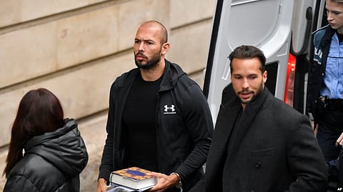 Andrew Tate (center) and his brother Tristan (right) are brought by police officers to the Court of Appeal in Bucharest on January 10. (AP)