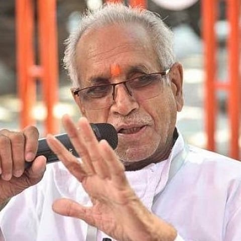 Image of Champat Rai Ram temple general secretary holding a mic at an event.