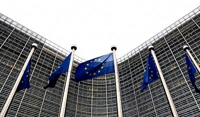 EU flags are seen outside the European Commission in Brussels, Belgium, Jan. 6, 2023.(Xinhua/Zheng Huansong/IANS)