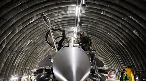 FILE - A Rafale jet fighter pilot checks and prepares his aircraft with the help of an army mecanic before leaving for a four-month mission to protect the airspace of the Baltic States, in southwestern France, on Nov. 25, 2022. (AFP)
