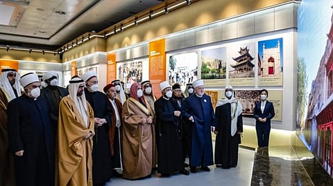 A delegation of more than 30 Islamic scholars and writers visits an exhibition in the Xinjiang International Convention and Exhibition Center in Urumqi, the capital of northwest China's Xinjiang region, Jan. 8, 2023. (Xinjiang Daily)