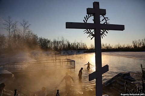 People bathe in temperatures that dropped as low as -14 degrees Celsius near the Achairsky monastery outside the Siberian city of Omsk, Russia, during Epiphany celebrations on January 19. Many Orthodox Christians around the world have been marking the Epiphany, one of the faith's three biggest celebrations. (AP)