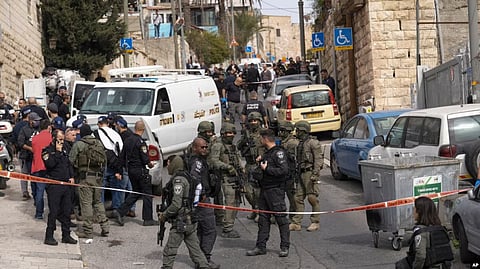 An Israeli policeman secures a shooting attack site in east Jerusalem, Saturday, Jan. 28, 2023. (AP)